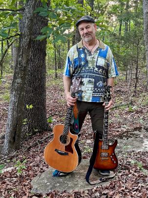Tim with acoustic and electric guitars